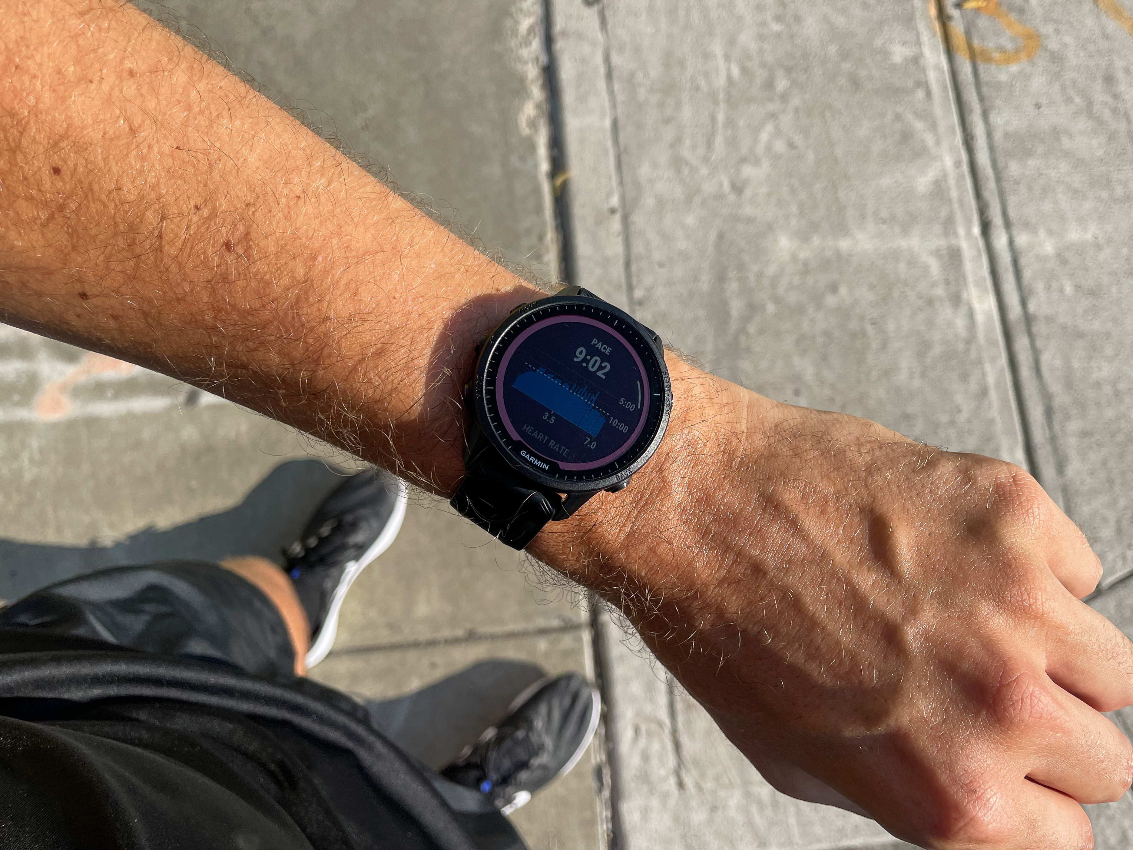 Garmin Forerunner 955 Solar on wrist showing pace information.