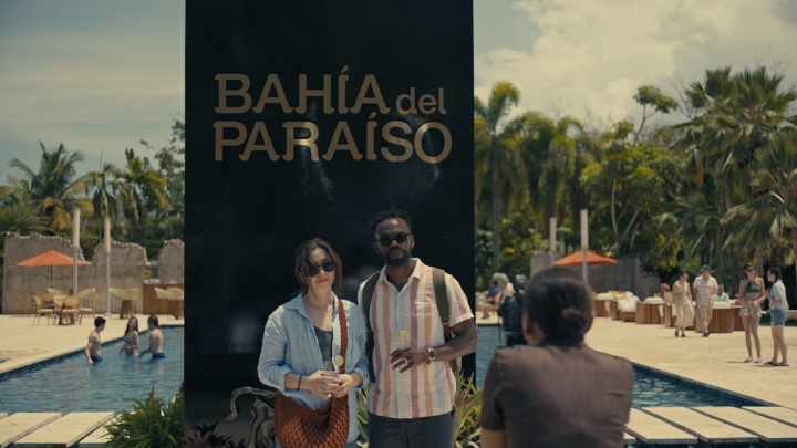 Cristin Milioti and William Jackson Harper standing next to each other in front of a pool in a scene from The Resort.