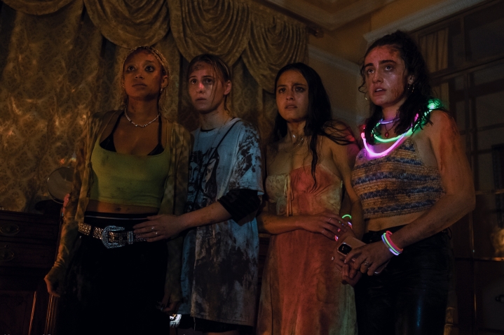 Sophie, Bee, Emma, and Alice stand together covered in blood in Bodies Bodies Bodies.