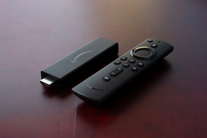 Amazon Fire TV Streaming Stick 4K on wooden table.